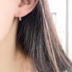 double row diamond huggies on ear
