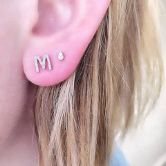 single petite initial post earring in white gold M on ear