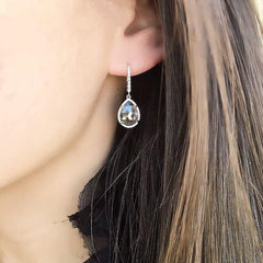 one of a kind rustic diamond earrings on ear