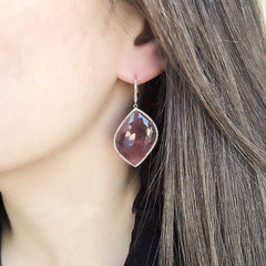 sapphire one of a kind earrings on ear