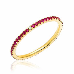 Ruby eternity band with compass point diamonds in yellow gold