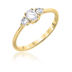 three rose cut diamonds on a yellow gold band. Center stone is oval, and 2 round side stones