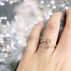 four rose cut diamond twist ring on hand